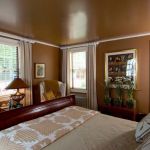 Short sleigh bed in a brown room