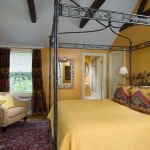 Steel 4 post bed in a yellow room
