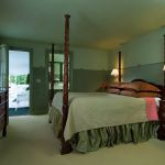 4 post bed in dark green room