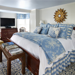High sleigh bed with blue sheets