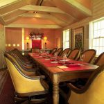 Large wooden table set for 14 people