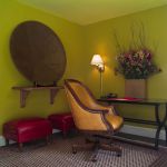 Brown leather chair and red stools