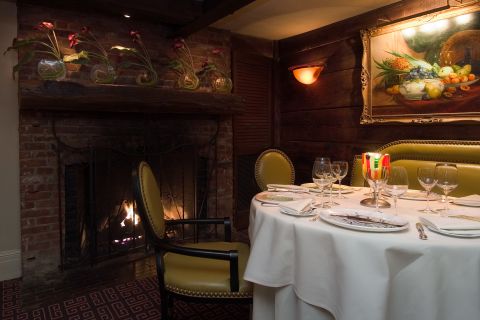 A Bedroom With A Bed And A Fireplace